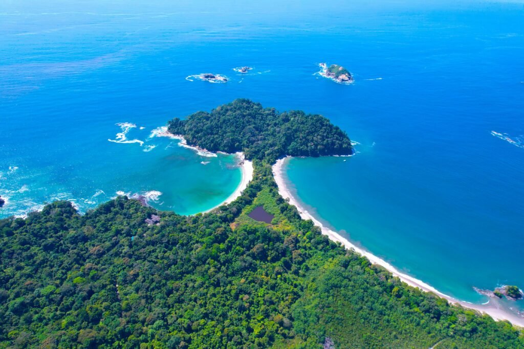 Stunning aerial shot of the lush coastline and turquoise waters of Manuel Antonio National Park, Costa Rica.