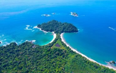 Stunning aerial shot of the lush coastline and turquoise waters of Manuel Antonio National Park, Costa Rica.