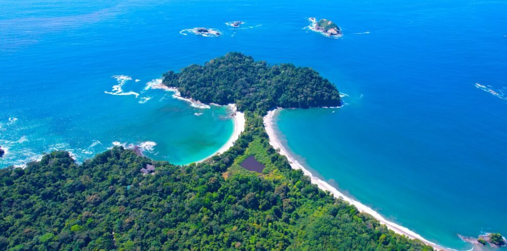 Stunning aerial shot of the lush coastline and turquoise waters of Manuel Antonio National Park, Costa Rica.