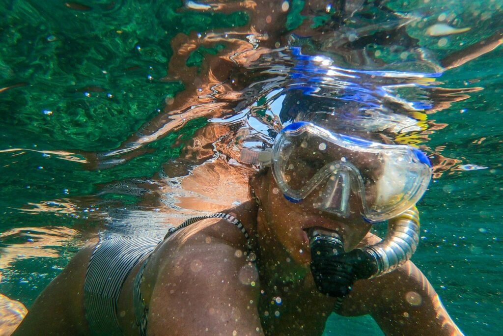 woman wearing goggles and snorkel In Manuel Antonio National PArk
